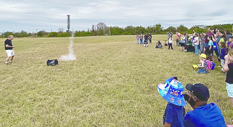 Visitors watch one of the rocket launches, and explore space through virtual reality, at the STEM Community Day Saturday at NeoCity. PHOTO/DEBBIE DANIEL