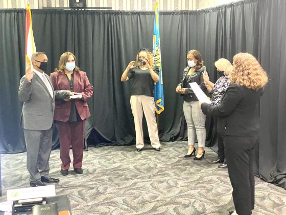 Kissimmee Commissioner Carlos Alvarez III, far left, is sworn in. NEWS-GAZETTE PHOTO/BRIAN MCBRIDE
