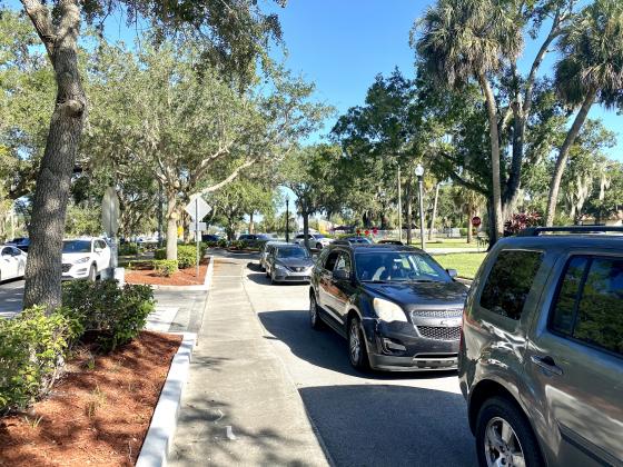 A line of cars wait for the food behind Kissimmee City Hall. NEWS-GAZETTE PHOTO/BRIAN MCBRIDE