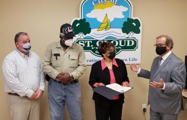 From left are City Manager Bill Sturgeon, honorees Gus Odom and Deloris McMillon and Mayor Nathan Blackwell.