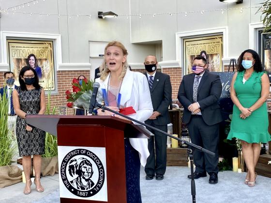 Kathleen Williams, school-related employee of the year, speaks after winning.