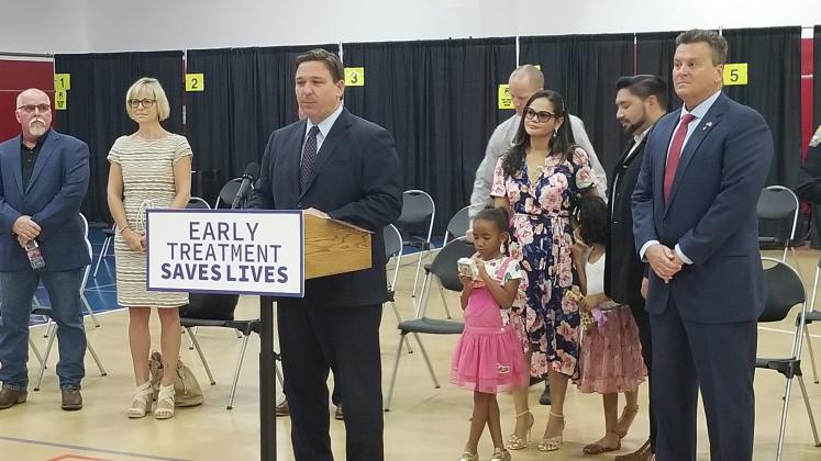 Gov. Ron DeSantis, joined by district 42 Rep. Fred Hawkins (far right), announces the opening of a monoclonal antibody COVID-19 treatment clinic at the St. Cloud Civic Center Tuesday. PHOTO/KEN JACKSON