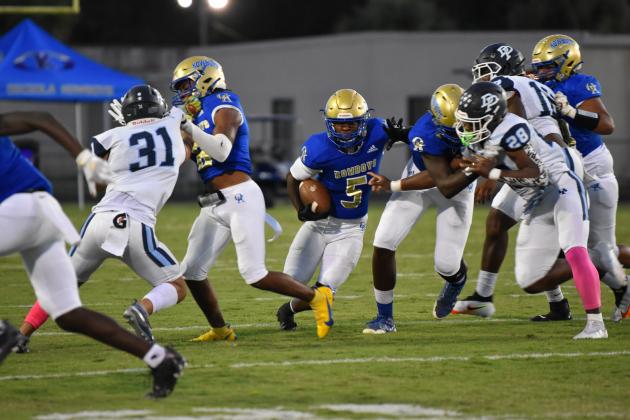 Ja'Randy Swint ran for a touchdown that gave Osceola a second-quarter lead over West Orange. The Warriors rallied for a 35-21 win, handing the Kowboys their first district loss since 2010. PHOTO/JANA STULTZ