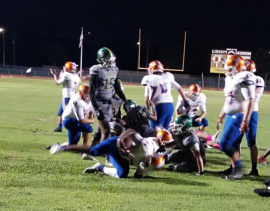 Tyler Emans powers into the end zone from 2 yards out for one of his five touchdowns in Harmony's 44-14 win over Liberty Friday. PHOTO/KEN JACKSON