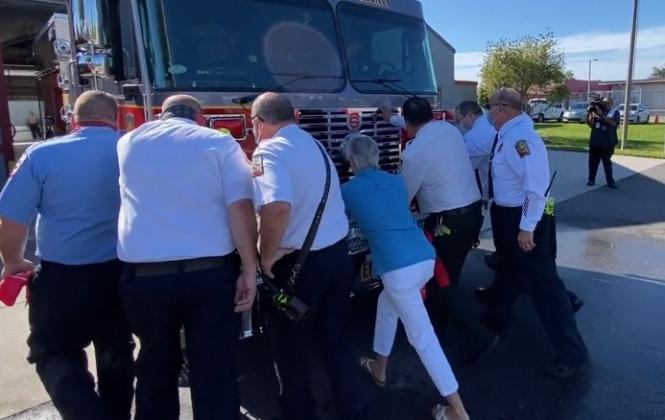 Fire and county leaders help with the ceremonial “push-back” of a new Station 63 fire engine. PHOTO/OSCEOLA COUNTY