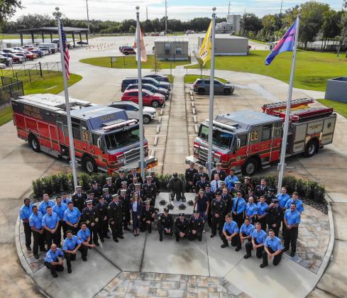 Members of the Osceola County Fire Rescue &amp; EMS department gather Friday to dedicated the new memorial monument to its fallen firefighters. PHOTO/OSCEOLA COUNTY FIRE RESCUE/EMS