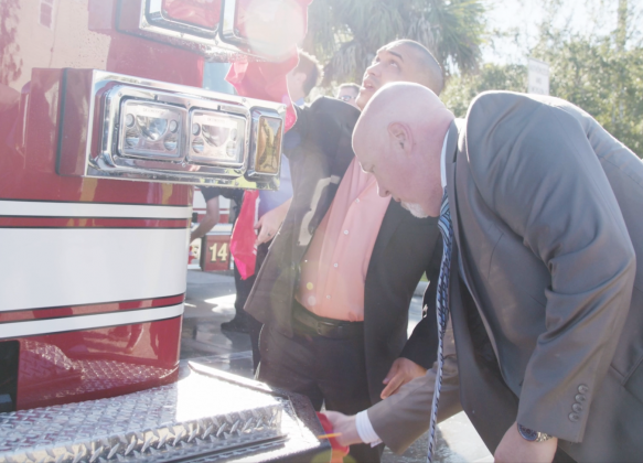 Kissimmee City Manager Mike Steigerwald and City Commissioner Felix Ortiz dry off one of the new engines