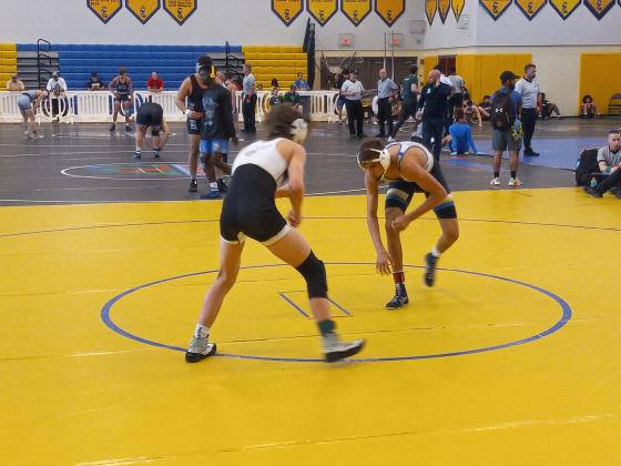 Osceola High’s Cooper Haase (right) circles Fleming Island’s Kaden Schaefer.  Haase would pin Schaefer in the second period to clinch win the top spot at 138 pounds.