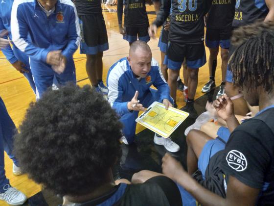 Coach Steve Mason draws up a play during the time-out of a recent game for the 7-1 Kowboys. PHOTO/DAN PEARSON