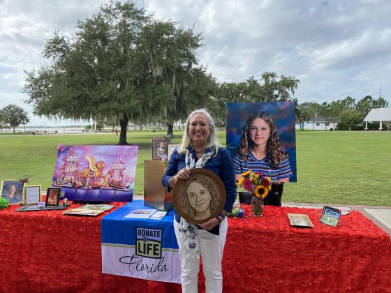 Diana Couch with a floragraph of her daughter Linda, who died in a 1999 car accident, but donated her organs and allowed others to live. Some of these items will appear on the DonateLife float at the Tournament of Roses Parade on Jan. 1. SUBMITTED PHOTO