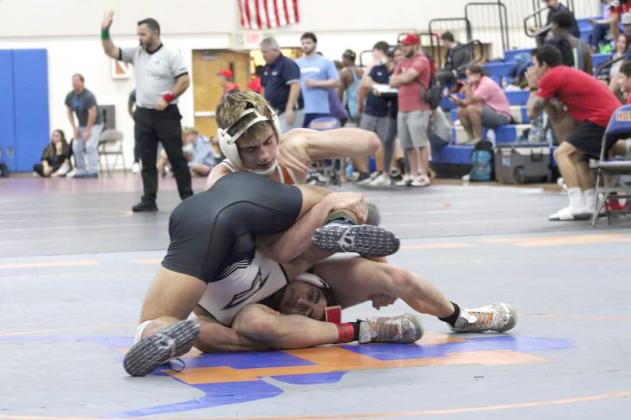Harmony’s J.C. McNichols (top) will lead his Longhorn teammates into the FHSAA District Dual Championships on Saturday at Winter Springs. McNichols is undefeated and the top-ranked wrestler in Class 3A at 145 pounds. PHOTO/J. DANIEL PEARSON
