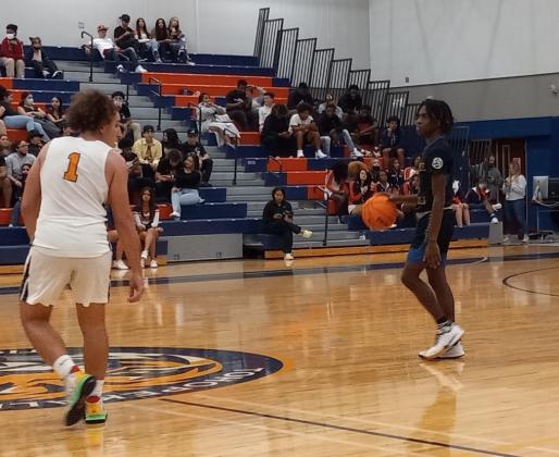 Chris Combs brings the ball up court against Tigers defender Josh Camejo.  Combs scored 11 second half points and 18 overall in leading the Kowboys to a 48-37 win Friday. PHOTO/J. DANIEL PEARSON