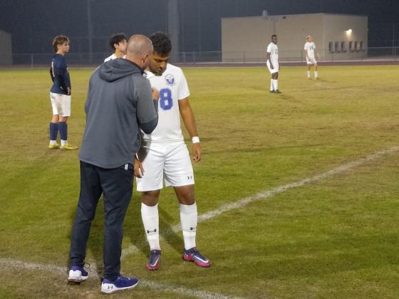 Coach Chad Boudreaux talks to striker Mohammed Raky during a break in the action of the Storms' 5-0 win over Tohopekaliga Thursday. PHOTO/J.DANIEL PEARSON