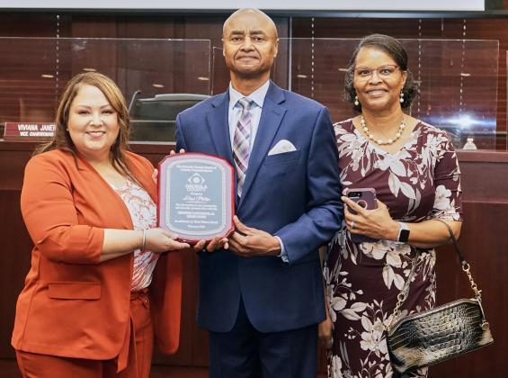 Lloyd Phillips, center, with Commission Chair Viviana Janer (left) and Phillips' wife, Delilah. PHOTO/OSCEOLA COUNTY