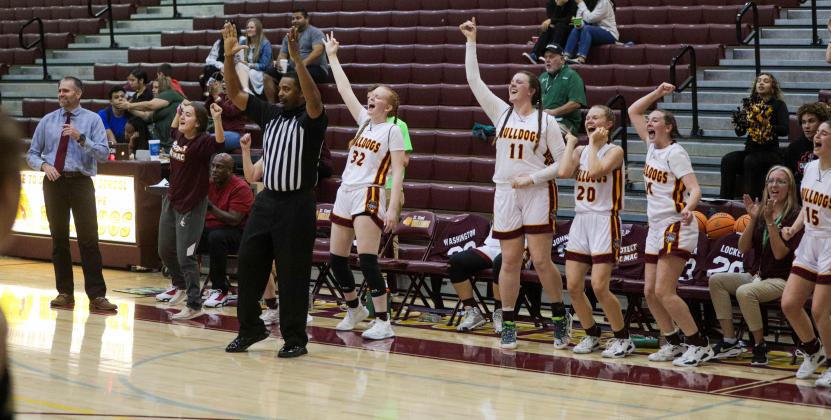 The St. Cloud Bulldogs celebrate one of their nine three-pointers in the District 6A-7 championship game. PHOTO/ROB HERBERT