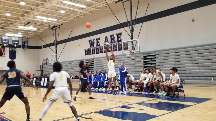 Tyler Newsome hits one of five three-pointers Osceola hit in the third quarter of an 82-52 District 9 championship rout of Tohopekaliga Friday at Lake Nona High. PHOTO/KEN JACKSON