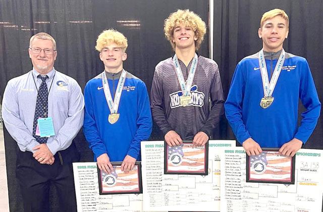 It never gets old: Osceola wrestlers (from left) Anderson Heap (126 pounds), Gunner Holland (160) and Cooper Haase (138), pictured with Coach Jim Bird, gave the Kowboys state champs for the 16th straight season. PHOTO/OSCEOLA H.S.