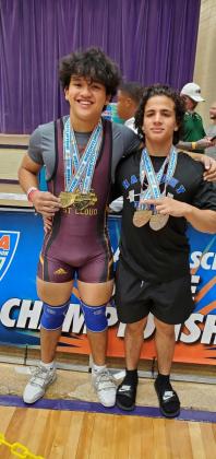 STATE CHAMPIONS!  St. Cloud’s Julian Sykes (left) and Harmony’s Isaac Balado (right) proudly display their gold medals after finishing first in the both the traditional and snatch competitions at the Class 3A state meet Thursday. PHOTO/CORY AUN, ST. CLOUD H.S.