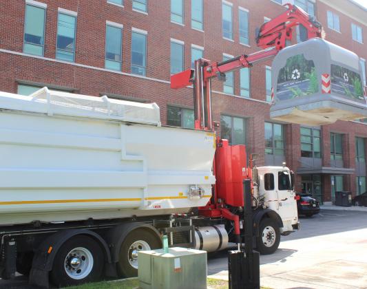 Underground Refuse Systems' technology involves the waste going into concrete receptacles dug underground, with a specialized truck using a small crane-like apparatus to lift the entire receptacle out of the ground to empty it. FILE PHOTO