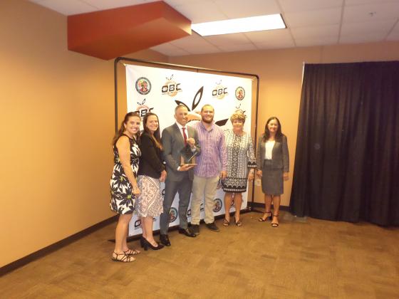 Surrounded by member of Coach Mike Fields’ Family, Cory Aun (3rd from left) accepted the Mike Fields Distinguished Leadership Award. PHOTO/DAN PEARSON