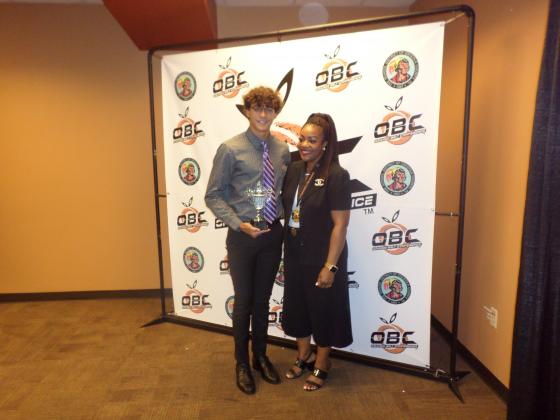 Osceola County Assistant Superintendent of High School Curriculum and Instruction Dr. Chundra Evens presents Gateway’s Paige Alise and Celebration’s Felipe Costa with their Orange Belt Conference Athlete of the Year Awards. PHOTO/DAN PEARSON