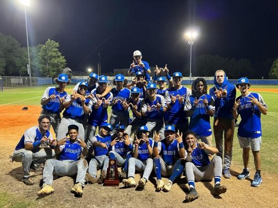 Kowboys baseball players pose with the District Championship Trophy for their fans. PHOTO/CARRIE PALMI