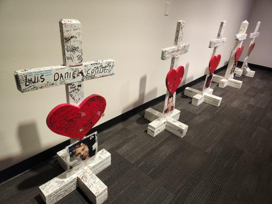 The crosses for Luis Conde (left) and Juan Rivera Velasquez are part of a memorial at the Orange County Regional Historical Center display through Sunday. PHOTO/KEN JACKSON