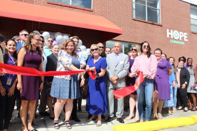 The community came together to triumphantly cut the ribbon Thursday on Hope Commons in downtown Kissimmee. PHOTO/KEN JACKSON