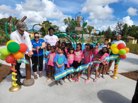 Boys &amp; Girls Club members help County Commissioner Viviana Janer cut the ribbon Monday. PHOTO/KEN JACKSON