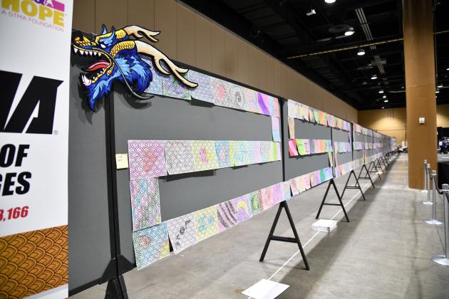 Some 3,600 colored pages lined up corner to corner formed a new Guinness Book record Friday at Gaylord Palms. PHOTO EXPERIENCE KISSIMMEE/KERI BURNS