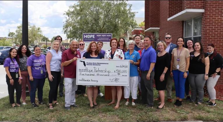 Elected officials, such as state Sen. Victor Torres, Rep. Kristen Arrington, U.S. Rep. Darren Soto Osceola County Commissioner Cheryl Grieb were on hand Thursday to present Hope Partnership CEO Rev. Mary Downey with funding to purchase and build affordable housing. PHOTO/HOPE PARTNERSHIP