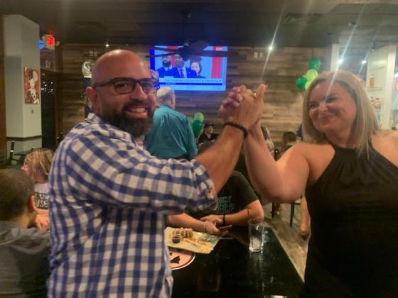 Will Fonseca, who received the most votes Tuesday in the School Board district 4 race and is headed to a Nov. 8 runoff against Heather Kahoun, celebrates with Janette Martinez, who won her Kissimmee City Commission election. PHOTO/NATALIE FEDOR