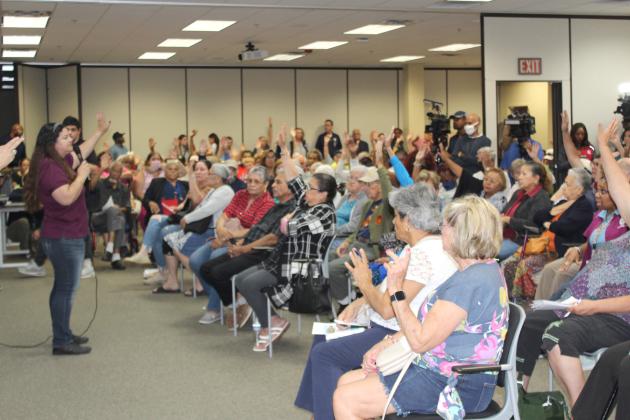 Good Samaritan Village residents who said they’ve registered with FEMA raise their hands at Monday night’s town hall meeting. PHOTO/KEN JACKSON