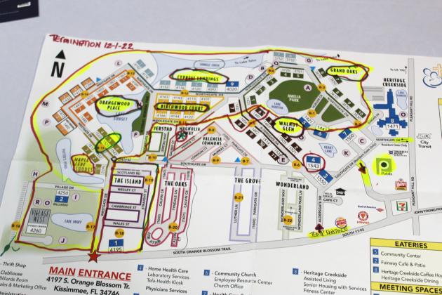 A resident shows a map from Good Samaritan Village. Those within the red circle at top and left are neighborhoods not intended to re-open. PHOTO/KEN JACKSON