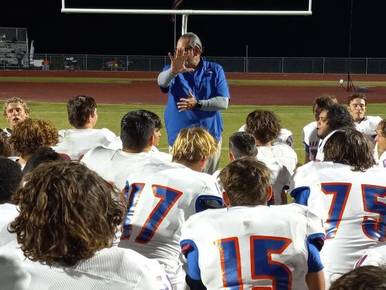 Harmony Coach Don Simon talks to his team after the Longhorns dismantled Tohopekaliga, 40-7, Friday. PHOTO/DAN PEARSON