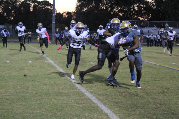 Osceola's Tavion Swint runs hard for some of his 85 yards in the 33-6 win over Mainland Friday. PHOTO/KEN JACKSON