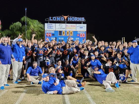 Harmony celebrates with the Brass Bugle after Friday's big win. PHOTO/KEN JACKSON