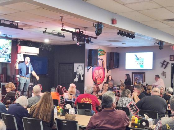 Kissimmee Park Road resident Cliff Clover presents the Osceola Action Committee logo and website at a community meeting Wednesday. PHOTO/KEN JACKSON