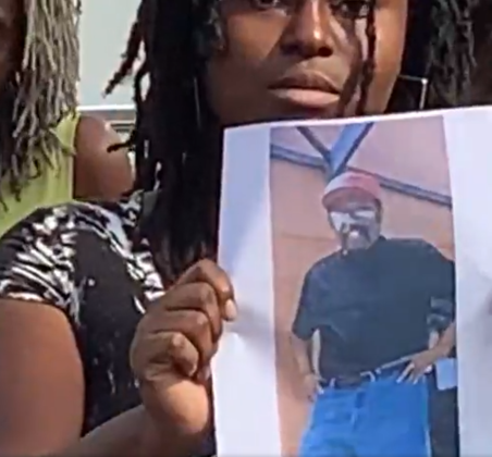Clara McClenton holds up a picture of her missing father, Herman, during a press conference Saturday. PHOTO/OSC. CO. SHERIFF'S OFFICE