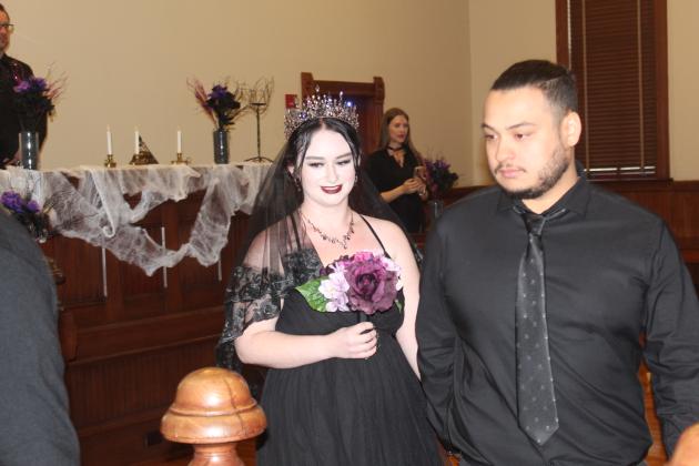 Maddie and Jorge Delgado — the bride was stunning in Halloween-inspired black number — said "I do" Monday as part of the "Scare-A-Mony." PHOTO/KEN JACKSON