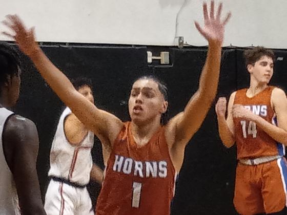 Miguel Tirado (1) defends an inbounds pass during Harmony’s 42-36 win over Gateway on Monday night.  PHOTO/J. DANIEL PEARSON