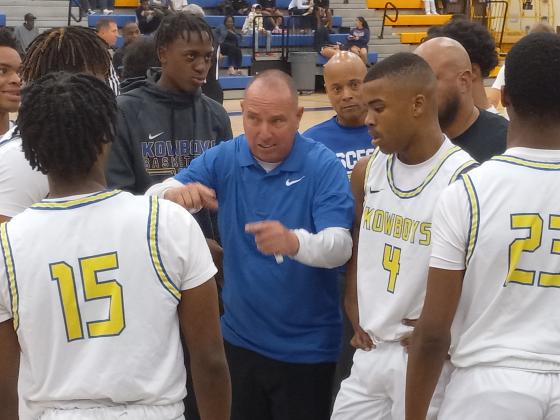Osceola Coach Steve Mason talks strategy with his team during a third quarter timeout in Tuesday's win over Gateway. PHOTO/DAN PEARSON