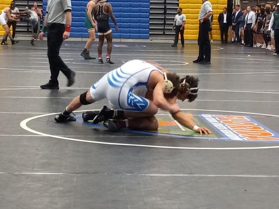 Osceola’s Anderson Heap (top) works a move on South Dade’s  Misha Arbos in the 142-pound weight class.  Anderson won his match 10-7 in overtime, but Osceola fell in the state championship, 42-9. PHOTO/DAN PEARSON