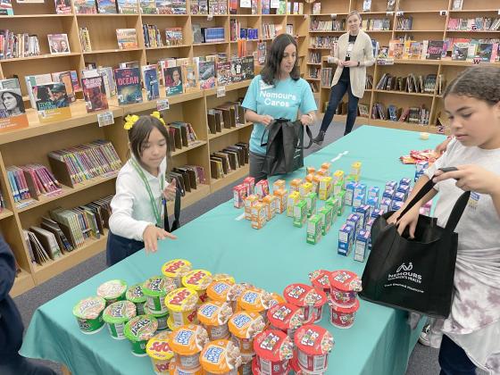 Nemours Children’s Hospital volunteers pack meals for Boggy Creek Elementary students to take home as part of the Blessings in a Backpack student food program. PHOTO/NEMOURS