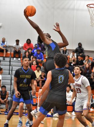 Osceola's Jamarion McCrimon skies for a rebound in Friday's Orange Belt Conference championship game. PHOTO/KATIE WILLIAMS