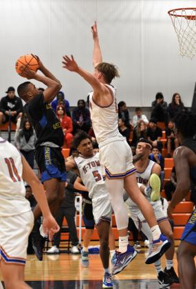 Osceola's Alex Springs goes up for a shot and Caden Scarborough defends in Friday's OBC boys basketball championship game. PHOTO/KATIE WILLIAMS