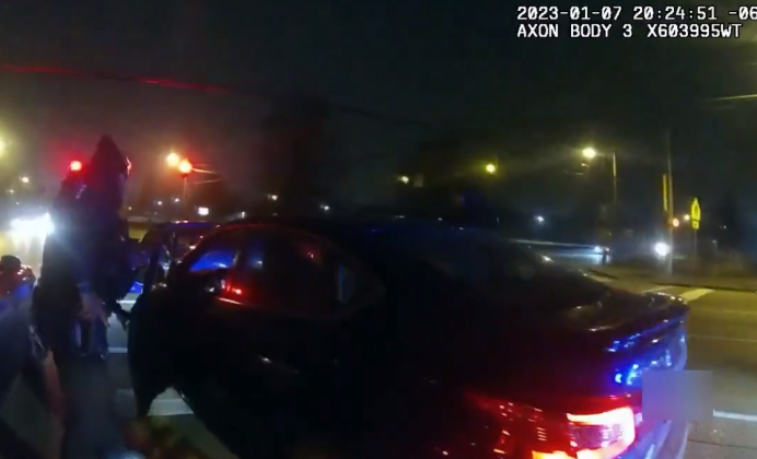 In a screen shot from the early part of video released by Memphis police, officers attempt to detain Tyre Nichols in his vehicle.