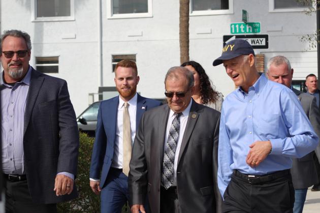 Senator Rick Scott chats with St. Cloud Mayor Nathan Blackwell and City Council members Ken Gilbert and Kolby Urban during a Wednesday visit. PHOTO/KEN JACKSON