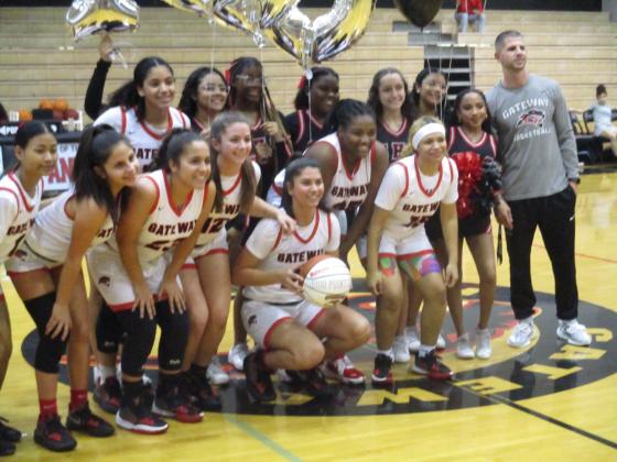 Gateway junior Malayna Stevenson (center kneeling) was presented a game ball Thursday to commemorate her 1000th career point with the Panthers. PHOTO/J. DANIEL PEARSON