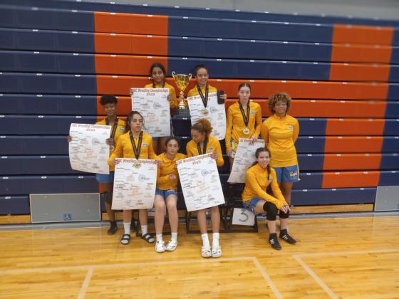 The Osceola girls’ wrestling team shows off their hardware after successfully defending their Orange Belt Conference team championship. PHOTO/J. DANIEL PEARSON